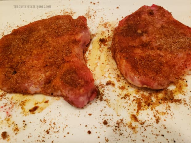 Spice mixture is rubbed into both sides of the pork chops before cooking.