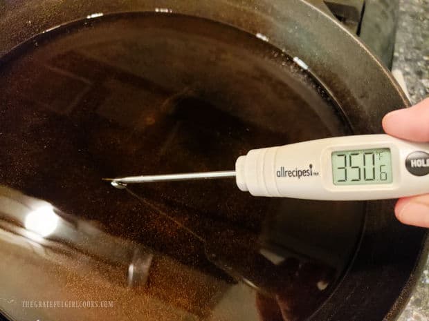 Vegetable oil is heated in skillet until is reaches a temperature of 350°F.