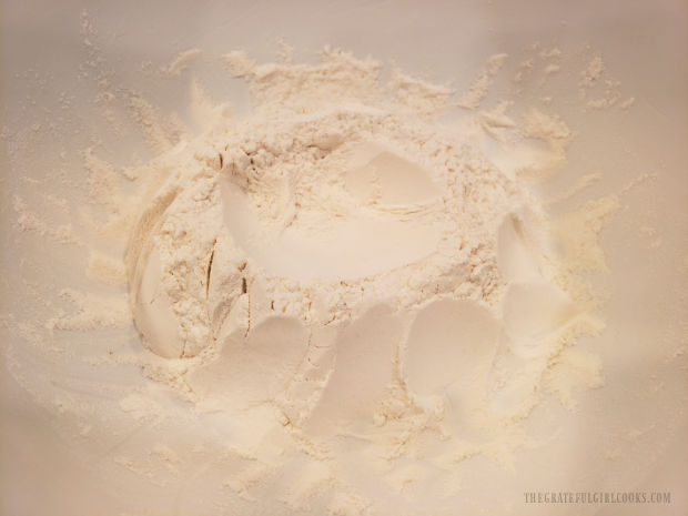 Flour and salt are combined into a mound and a "well" is made in the middle.