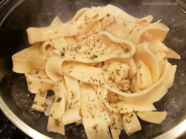 After cooking, noodles can be mixed with butter and dried parsley for serving.