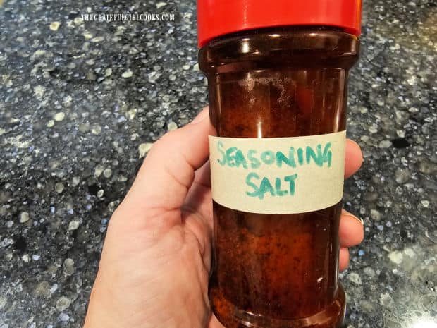 The seasoning salt is transferred to a labeled container for storage.