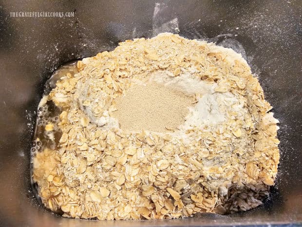 Bread loaf ingredients are added to bread pan in a specific order.