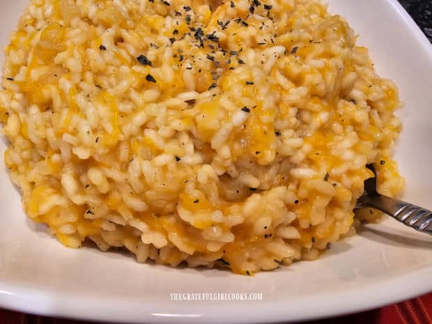 Dried basil is sprinkled on top of the risotto before serving.