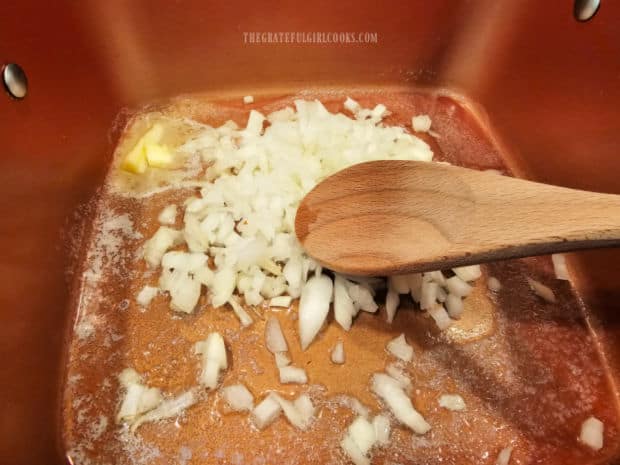 Chopped onions are cooked until tender in melted butter.