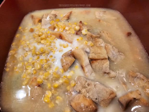 Frozen corn is added to the saucepan.