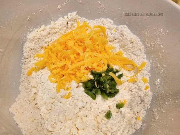 Grated cheddar cheese and diced jalapeños are added to dough mixture.