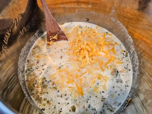 Lots of shredded cheddar cheese is stirred into the hot soup until melted.