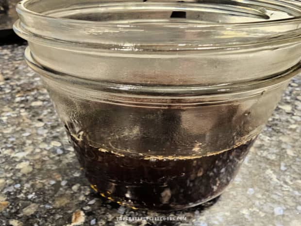 Very strong brewed hot coffee is added to a pint sized canning jar.
