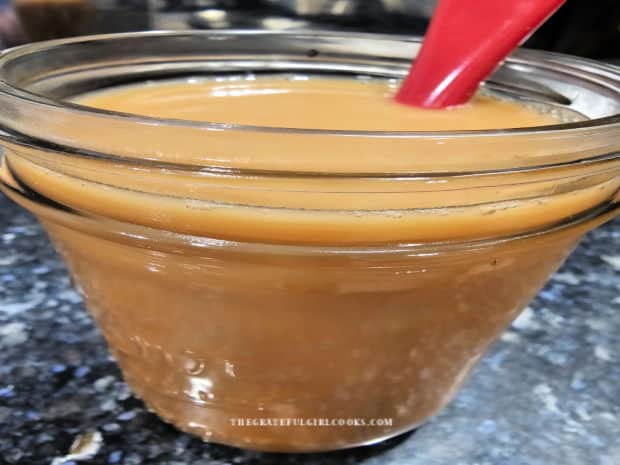 Almond milk is added and stirred into the coffee mixture.