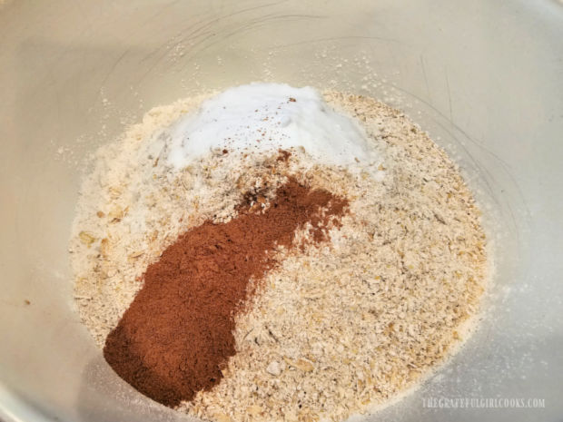 Flour, oat and spices are combined in a bowl.