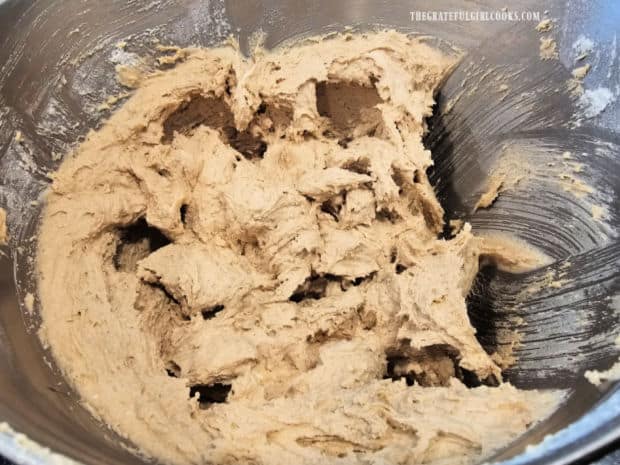 Cookie dough is thick after dry ingredients have been added.