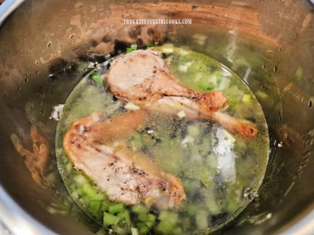 Four cups of water is added to the pot, submerging the veggies and beans.