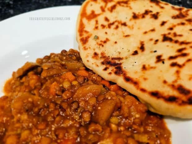 Garlic Butter Naan Bread is served with lentil potato soup.