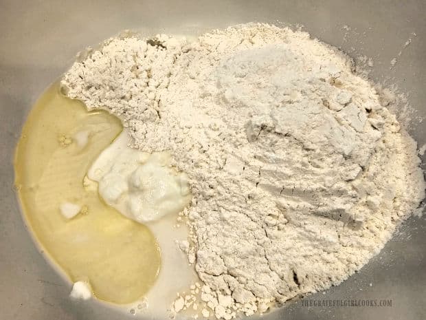 Milk, yogurt, flour, etc. are added to the yeast mixture in bowl.