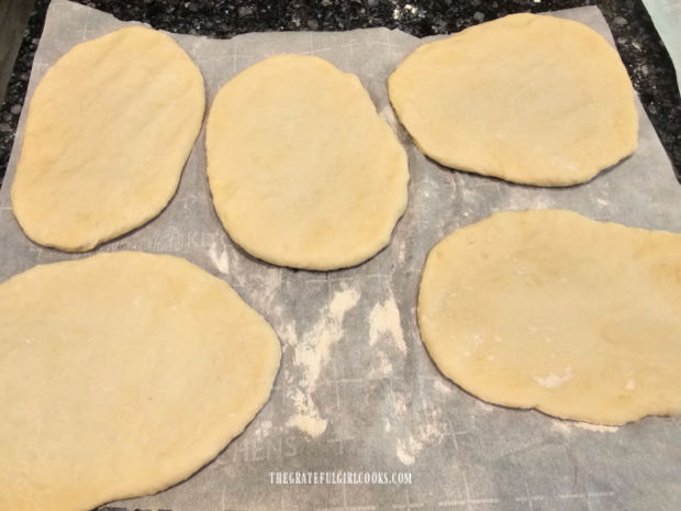 Each portion of naan dough is rolled into 10 oval-shaped pieces.