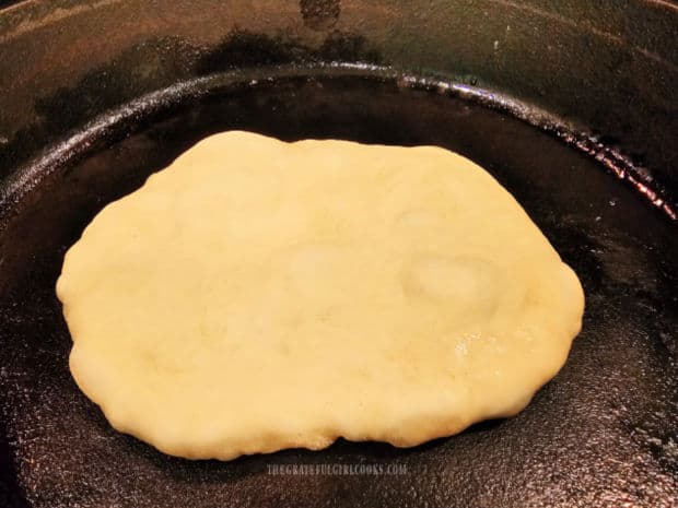 Pockets of air appear on the surface of the Naan bread as it cooks.