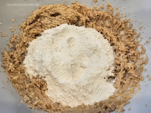 Flour, baking soda and salt are stirred into the cookie dough batter.