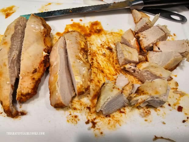 Cooked chicken is removed from Instant Pot and cut into large cubes.