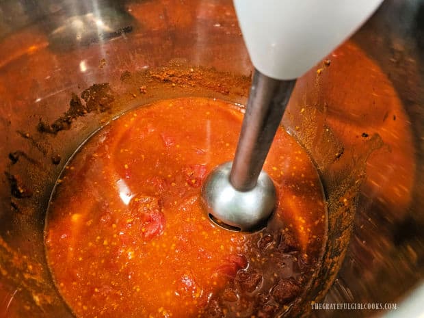 Immersion blender is used to puree the tomato/spice mixture in the Instant Pot.