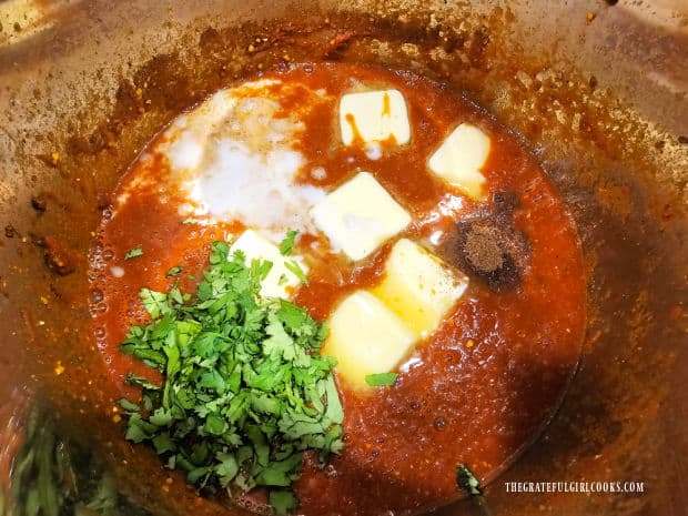 Butter, coconut milk, garam masala and cilantro is added to the sauce.