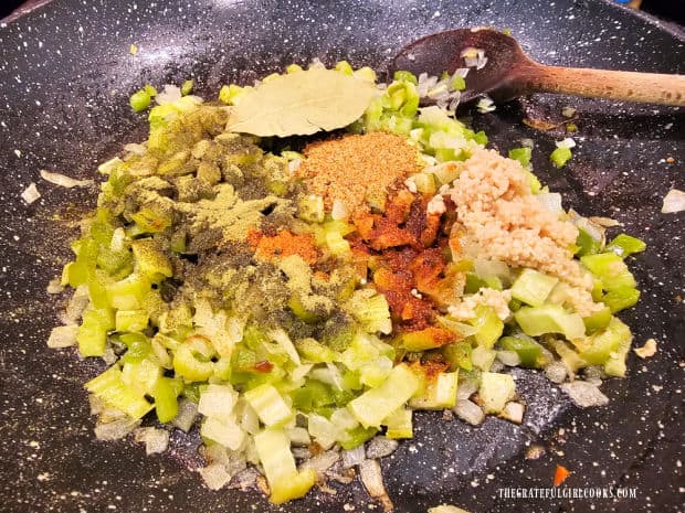 Minced garlic, a bay leaf and Creole spices are added to cooked veggies.