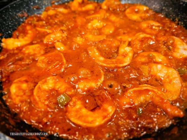 The shrimp are fully cooked in the Creole sauce and are ready to be served.