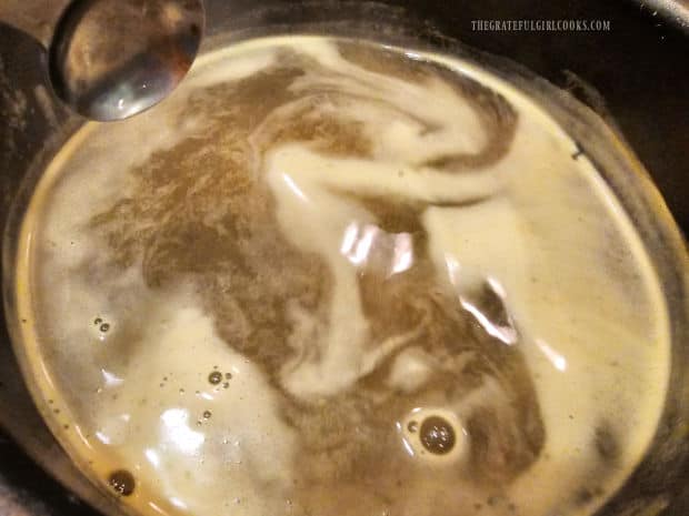 Chicken broth simmers in a pan before being added to couscous.