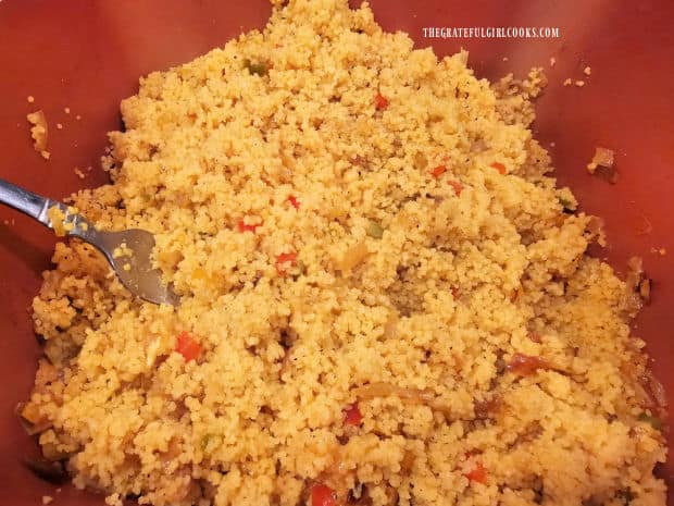 The couscous is fluffed with a fork before serving.