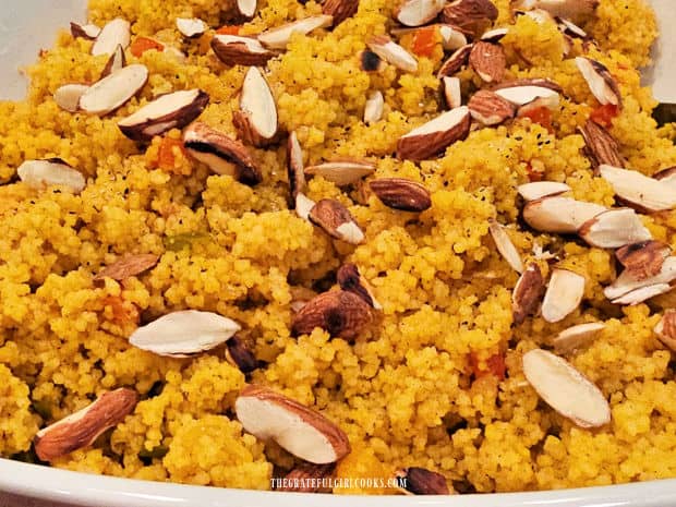 Golden Almond Couscous, served hot, in a white bowl.