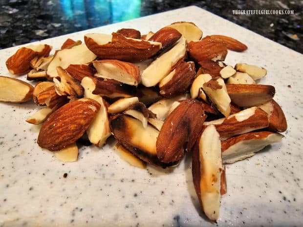 Almond slices are toasted in a skillet, then cool before using as a garnish.