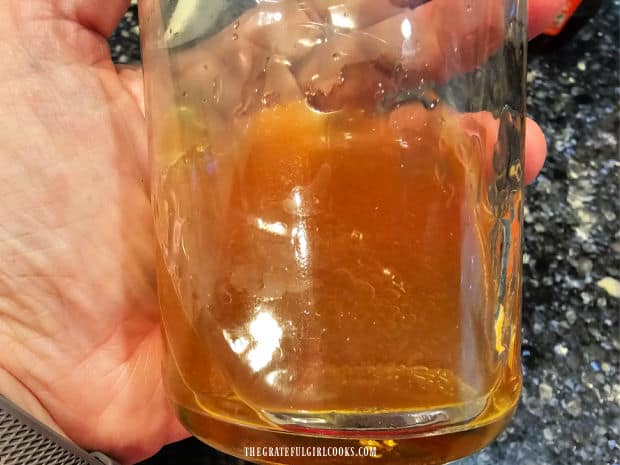 Vegetable oil and cider vinegar are combined in a small jar with a lid.