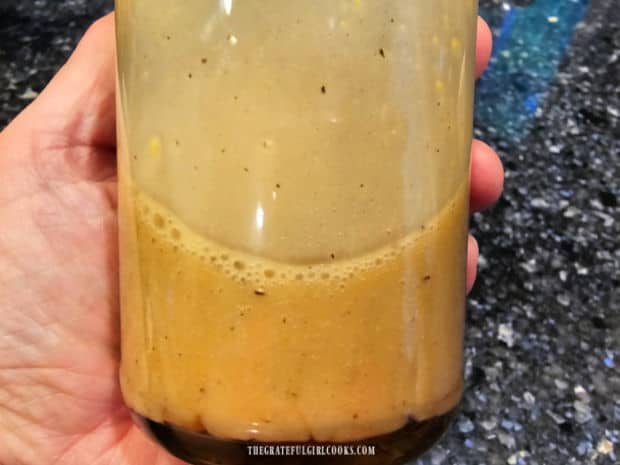 Dijon mustard, honey, salt and pepper are added to jar of salad dressing.