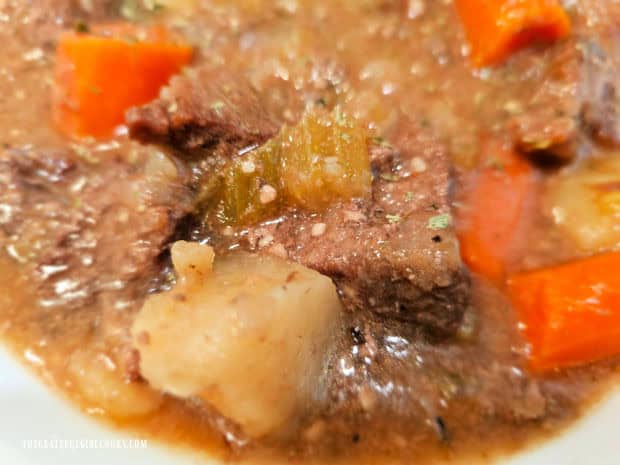 A close up photo of the beef, potatoes and carrots in the beef stew.