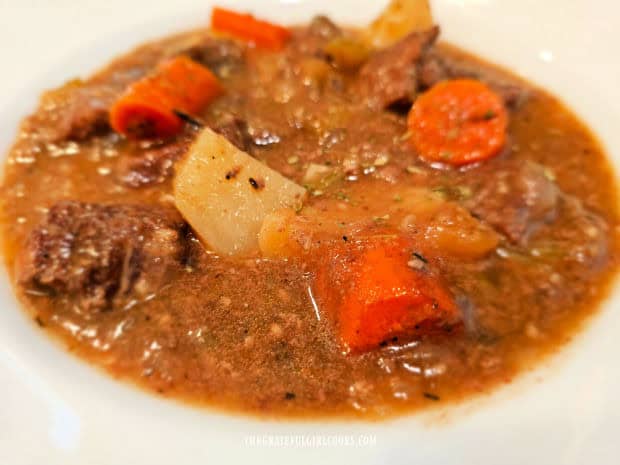 White bowl, filled with hot and delicious beef stew.