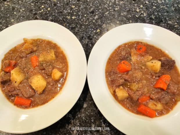 Two white bowls, filled with Instant Pot Beef Stew, ready to be enjoyed.