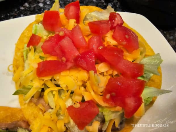 Diced fresh tomatoes are added to the top of the tostada.