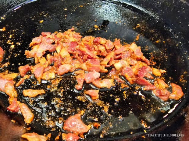 Bacon pieces are cooked until crisp, then removed from skillet to drain.