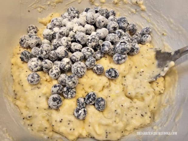 Flour-covered blueberries are added to the muffin batter.