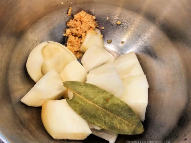 Onion wedges, garlic and a bay leaf ready to go into the Instant Pot.