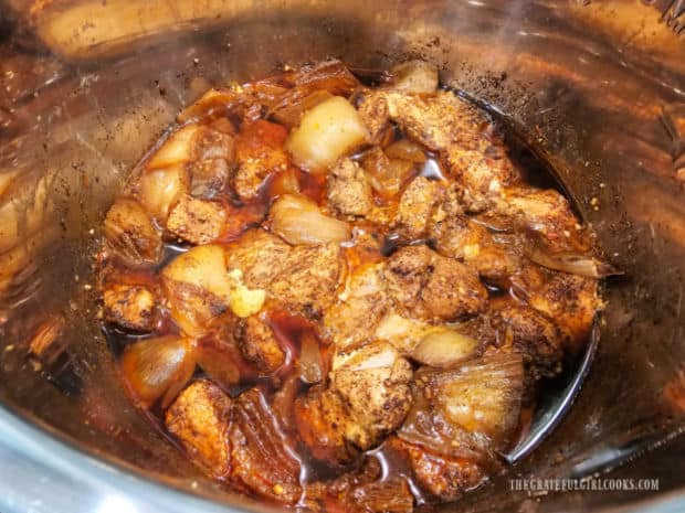 After pressure cooking, the pork will be removed from the Instant Pot, to shred.