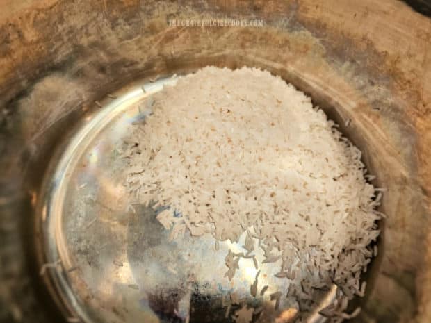 After rinsing, white rice is put into the inner pan of the Instant Pot.