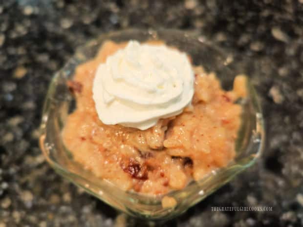 A serving of Instant Pot Rice Pudding with whipped cream on top.