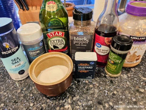 The ingredients used to make Italian Vinaigrette are shown on kitchen counter.