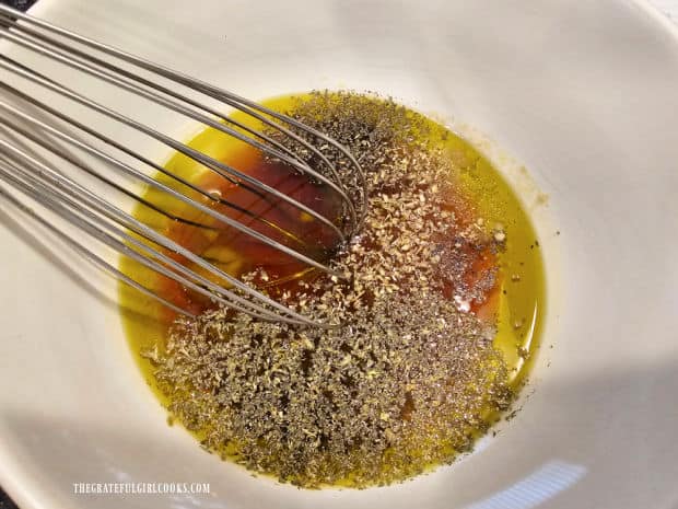 A wire whisk is used to fully blend the ingredients for the salad dressing.