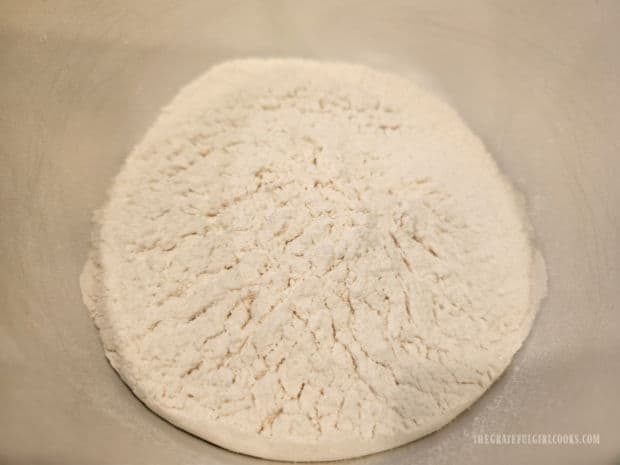 Flour, baking powder and a pinch of salt are combined in a bowl.