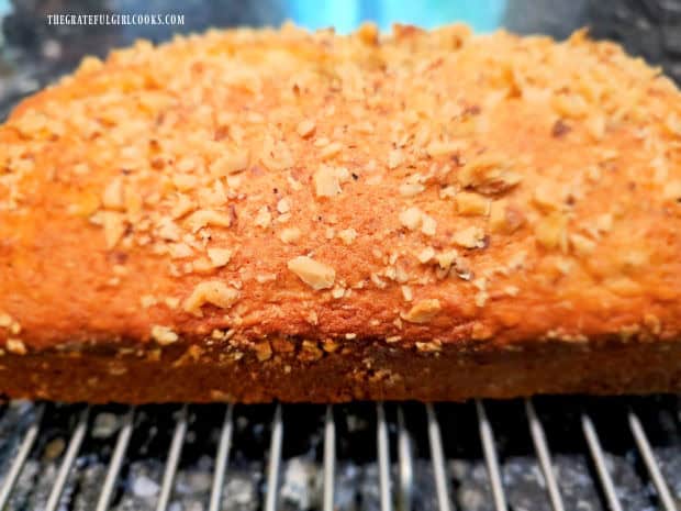 A side view of pineapple walnut bread, cooling on a wire rack.