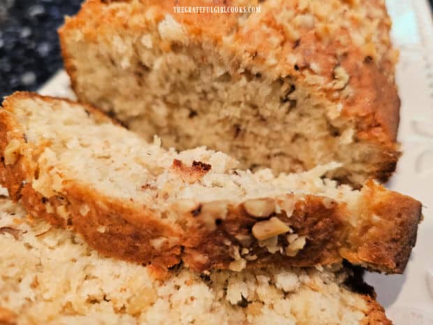 Slices are cut from the loaf of pineapple walnut bread.