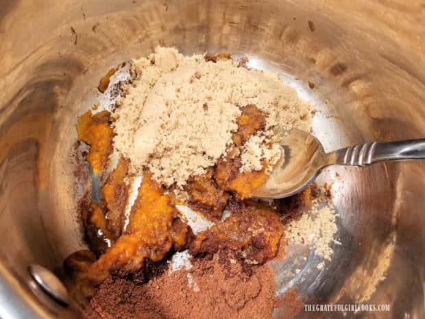 Brown sugar and pumpkin puree are stirred into the pumpkin spice mixture.