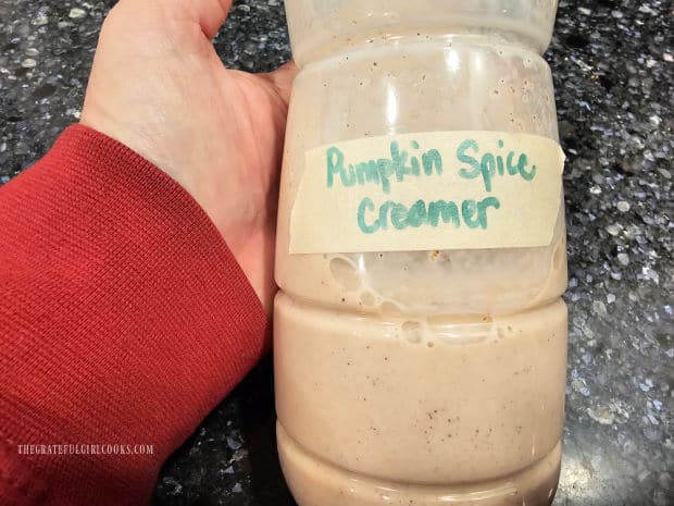 Pumpkin spice creamer, in a plastic bottle with a label on it.