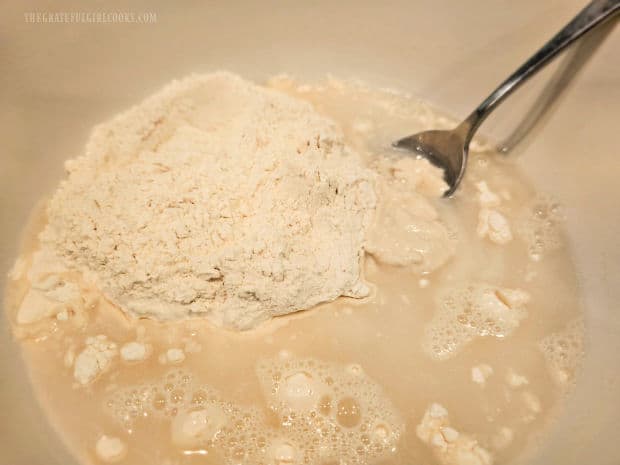 Flour, salt, yeast and water are combined in a large bowl.